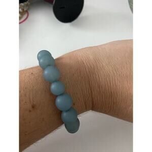 Light blue bead bracelet with pink accent